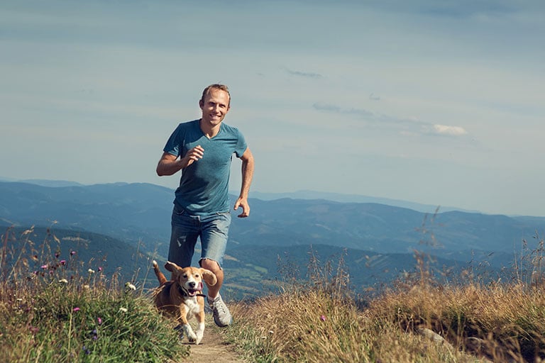 MAn running with dog