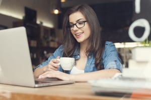 29187596 - beautiful hipster woman using laptop at cafe